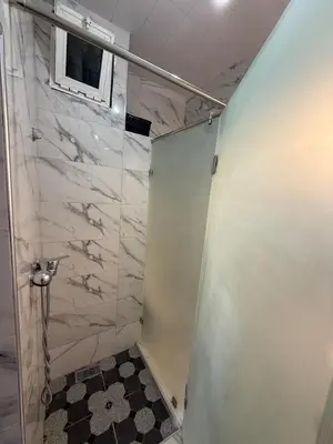 a shower with a glass door in a bathroom at Appartement central à Témara, proche de Rabat in Temara