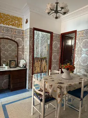 a dining room with a table and chairs and a mirror at Appartement central à Témara, proche de Rabat in Temara