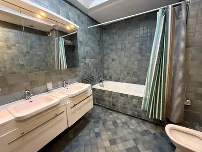 a bathroom with two sinks and a tub and a toilet at Cozy Downtown Apartment - Casa Port TGV in Casablanca