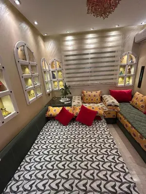a living room with a couch and a table at Grand appartement romandie in Casablanca