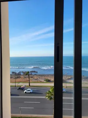a view of the ocean from a window at Appartement vue sur mer 3 chambres in Rabat