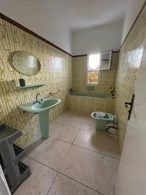 a bathroom with a sink and a toilet at Villa Val d'Or in Temara