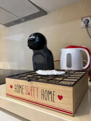 a home sweet home sign on a counter with a coffee pot at Cozy & Chill à 30min terrain de foot Netflix, AC pool & beach 2 min, in Bouznika