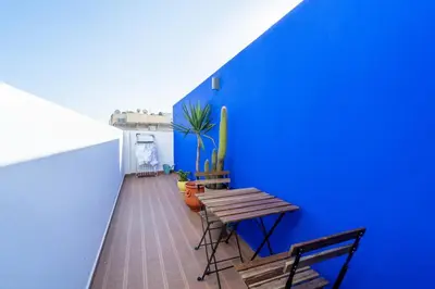a blue wall with a wooden table and a bench at C14- 1BR Luxury Apartment -Terrace Majorelle in Casablanca