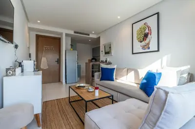a living room with a couch and a table at C14- 1BR Luxury Apartment -Terrace Majorelle in Casablanca