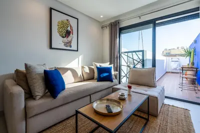 a living room with a couch and a table at C14- 1BR Luxury Apartment -Terrace Majorelle in Casablanca
