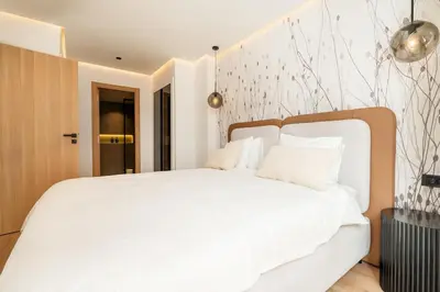 a bedroom with a white bed with white pillows at C13 - 1BR Suite - Private Gym - Terrace - Rooftop in Maarif