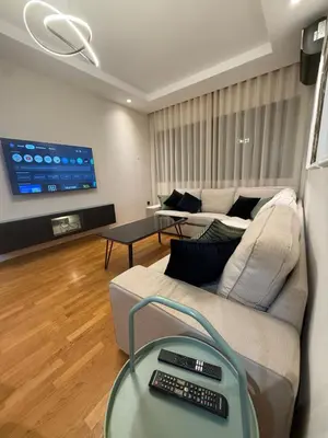 a living room with a couch and a tv at Marina, Medina et Bab Marrakech 8 min Hassan 2 in Casablanca