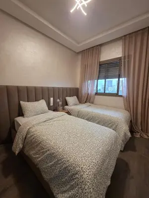 a bedroom with two beds and a window at Appartement in Casablanca