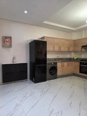 a kitchen with a black refrigerator and a dishwasher at Appartement in Casablanca