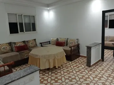a living room with a couch and a table at Appartement temara in Temara