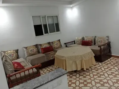 a living room with a couch and a table at Appartement temara in Temara