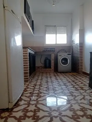 a room with a washer and dryer in a room at Appartement temara in Temara
