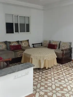 a living room with a couch and a table at Appartement temara in Temara