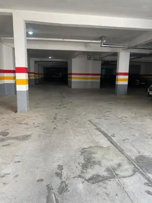 an empty parking garage with red yellow and white columns at New ground floor apartment - Large terrace direct access to pool in Bouznika