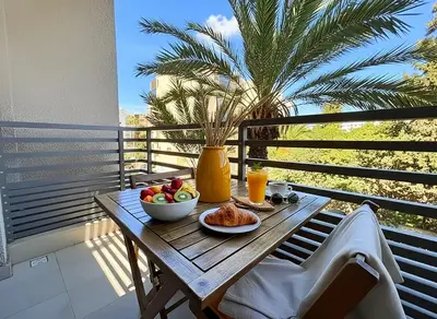 a table with a bowl of fruit on a balcony at Maya Suites - Riviera B Casablanca in Casablanca