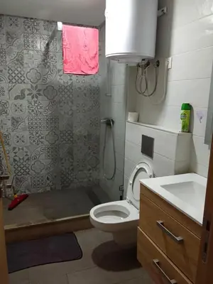 a bathroom with a shower and a toilet and a sink at Apartment kamal park F1 in Mohammedia