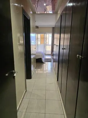 a hallway with a room with a bed and a mirror at Central Casablanca Apartment Steps from Hassan II Area in Casablanca