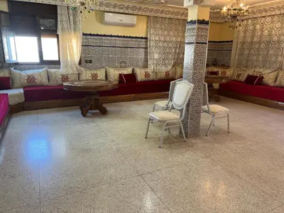 a room with two chairs and a table and a couch at Naima in Rabat