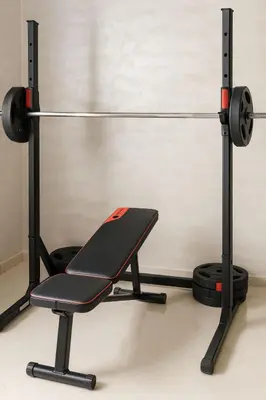 a bench in a gym with a barbell at Spacieux RDC avec salle de sport privative in Bouznika