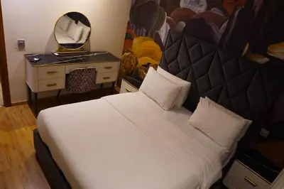 a bedroom with a large bed and a mirror at Modern Studio with Rooftop Pool & Free Parking in Casablanca