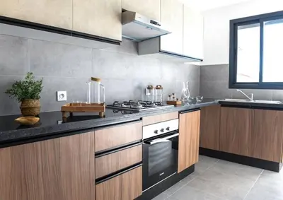 a large kitchen with a stove and a sink at Appartement Steps from Anfa Park Fanzone in Casablanca