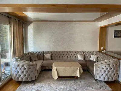 a living room with a large couch and a table at Apartment luxurious a Hay Riad in Rabat