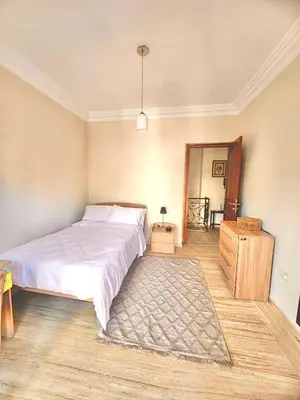 a bedroom with a white bed and a rug at Luxurious Ocean View Villa Ain Diab in Casablanca