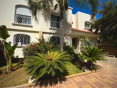a white house with palm trees in front of it at Luxurious Ocean View Villa Ain Diab in Casablanca