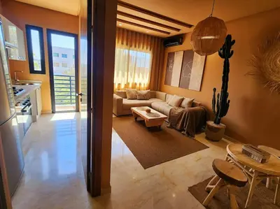 a living room with a couch and a table at Oasis de Sérénité avec Piscine in Casablanca