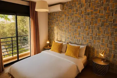 a bedroom with a bed with yellow pillows and a window at Cosy-Piscine-Parking in Casablanca