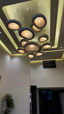 a group of lights hanging from a ceiling at studio luxe rooftop & gym quartier des princess in Casablanca
