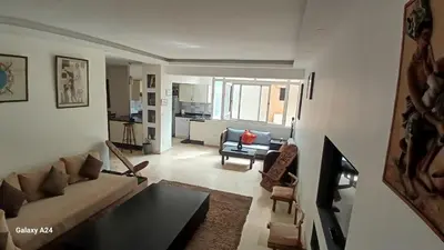 a living room with a couch and a table at Bel Appartement au cœur de Casablanca in Casablanca