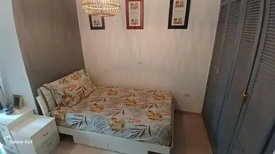 a small bedroom with a bed in a room at Bel Appartement au cœur de Casablanca in Casablanca