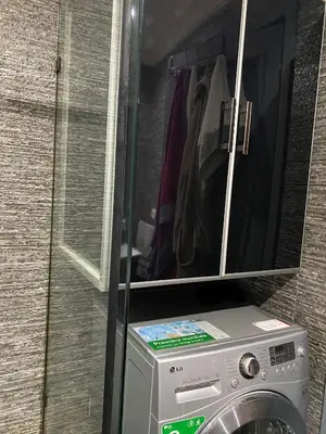 a washing machine with a cabinet above it at Bel Appartement au cœur de Casablanca in Casablanca