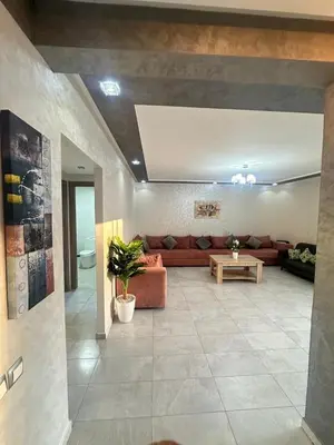 a living room with a couch and a table at Marbella beach residency in Mansouria