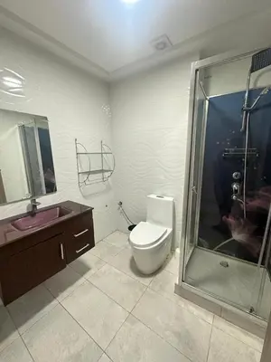 a bathroom with a toilet and a sink and a shower at Marbella beach residency in Mansouria