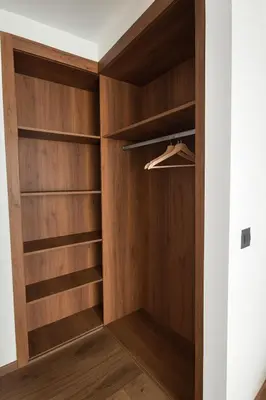 a walk in closet with wood paneling at My Cosy Place Cosy Apartment Casa gare Oasis in LʼOasis