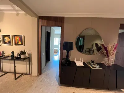 a living room with a large mirror on the wall at Beautiful 2 suites apartment modern cozy and central in Casablanca