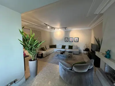 a living room with a couch and a table at Beautiful 2 suites apartment modern cozy and central in Casablanca