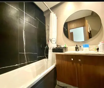 a bathroom with a tub and a sink and a mirror at Beautiful 2 suites apartment modern cozy and central in Casablanca