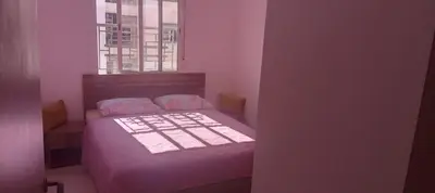 a small bedroom with a bed and a window at Cosy studio dar bouazza in Casablanca