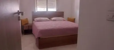 a bedroom with a bed with pink sheets and a window at Cosy studio dar bouazza in Casablanca