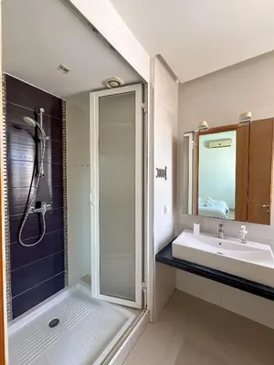 a bathroom with a sink and a shower at Upper floor of a villa, Modern and bright in Rabat