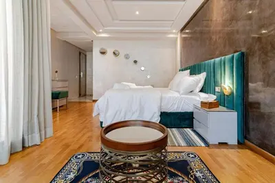 a large bedroom with a bed and a table in it at Large Comfort Duplex Casablanca Center in LʼOasis