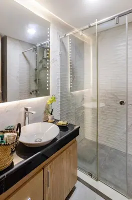 a bathroom with a sink and a glass shower at Large Comfort Duplex Casablanca Center in LʼOasis