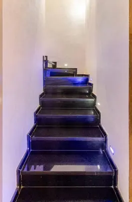 a staircase with blue paint on the side of a building at Large Comfort Duplex Casablanca Center in LʼOasis