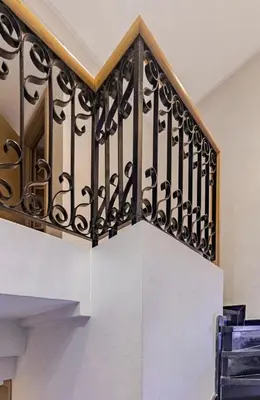 a staircase with black railing in a house at Large Comfort Duplex Casablanca Center in LʼOasis