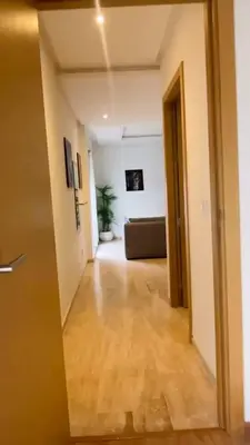 a hallway with a living room with a couch at Studio de standing à maarif in Maarif