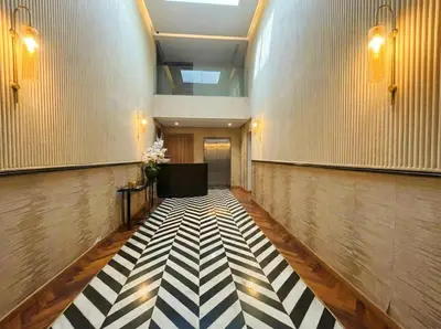 a hallway with a black and white checkered floor at Maya Suites - Mohamed V Stadium - Casablanca in Casablanca
